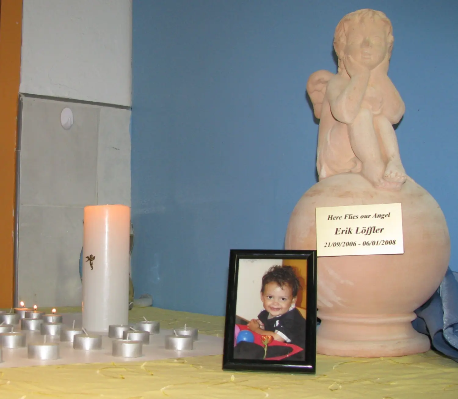 Natlie Ann Löffler, Candles in the memorial of a child, and a small statue