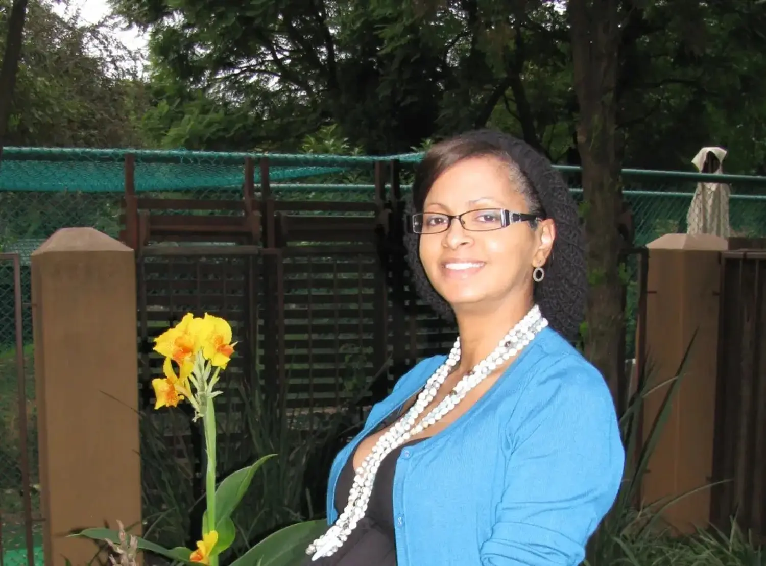 Natlie Ann Löffler, A woman smiling and holding a yellow flower