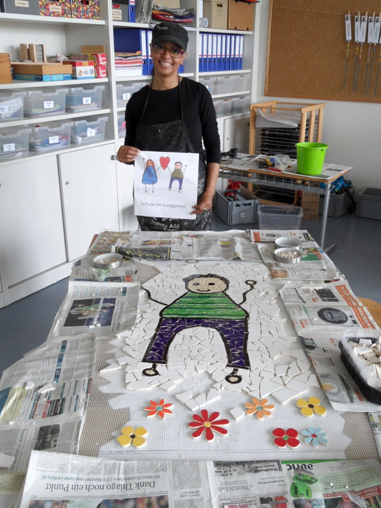 Natlie holding a drawing in her hands and, Mosaic art of a kid