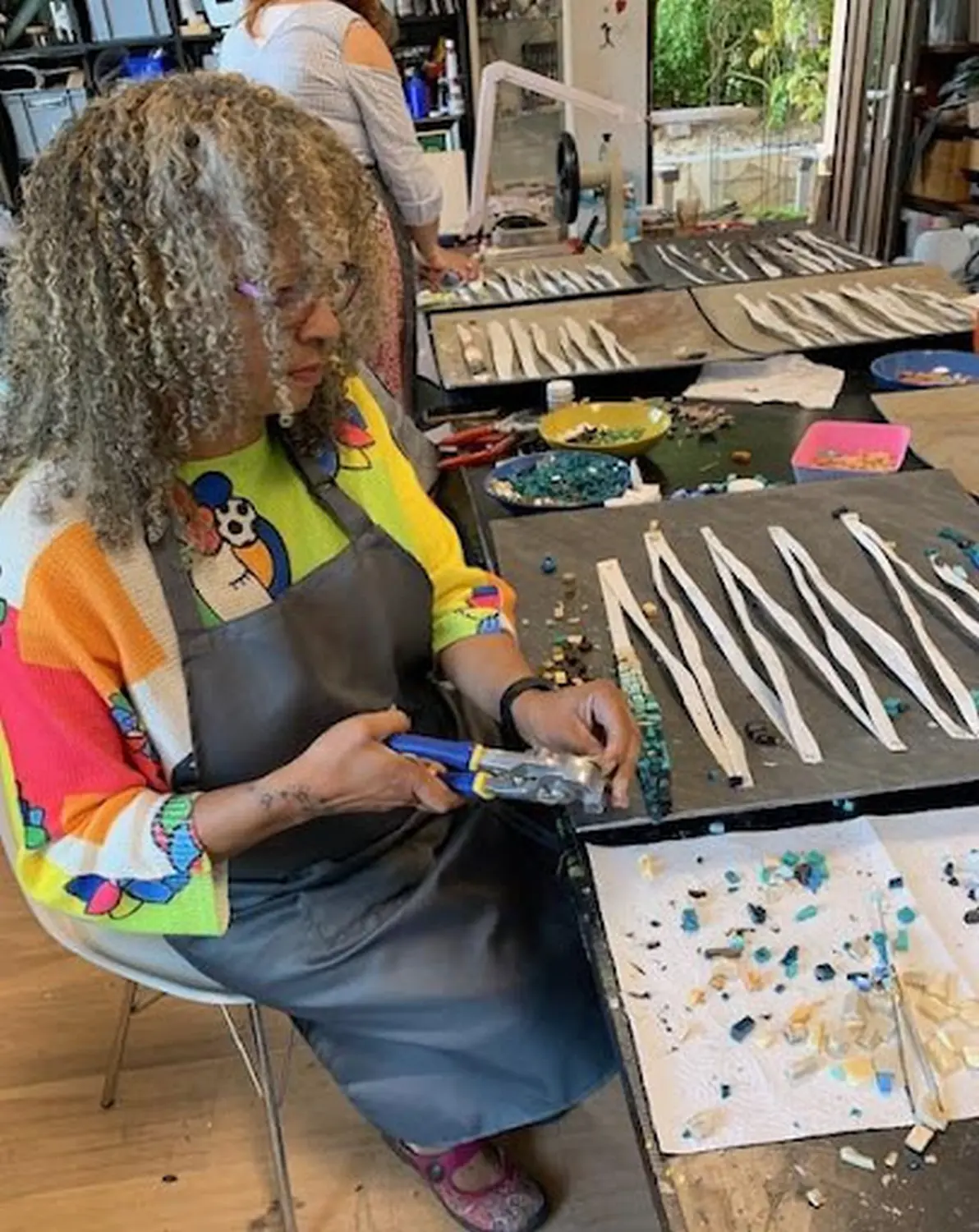 Natlie in workshop working on mosaic art